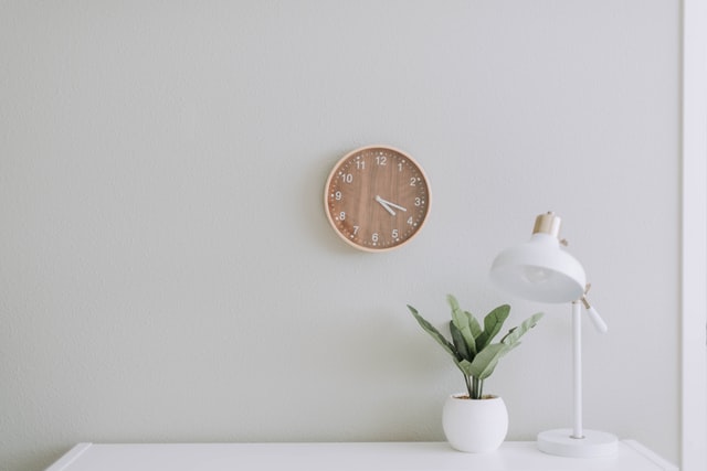 desktop table with a lamp and clock